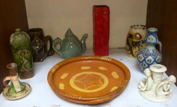 A slipware pottery dish, a Korean 'Koryo' tepot, red lava vase, angel chamberstick and other