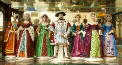 A set of seven Sitzendorf figures of Henry VIII and his six wives, comprising King Henry VIII,