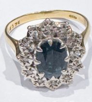 An 18ct yellow gold dress ring, claw set to the centre with an oval blue stone, surrounded by 12 x