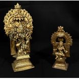 Two copper alloy sculptures of Indian Deities, each with removable back sections, raised on pedestal