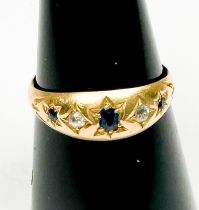An 18ct yellow gold gypsy style ring, star-set with 3 x sapphires and 2 x diamonds, hallmarked