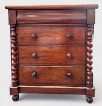 A Victorian mahogany chest of three long, graduated drawers with turned pulls and pulvinated
