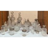 A pair of thistle-shaped cut-glass decanters together with ten various silver-topped cut-glass