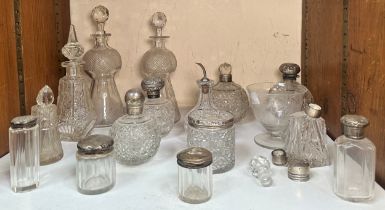 A pair of thistle-shaped cut-glass decanters together with ten various silver-topped cut-glass