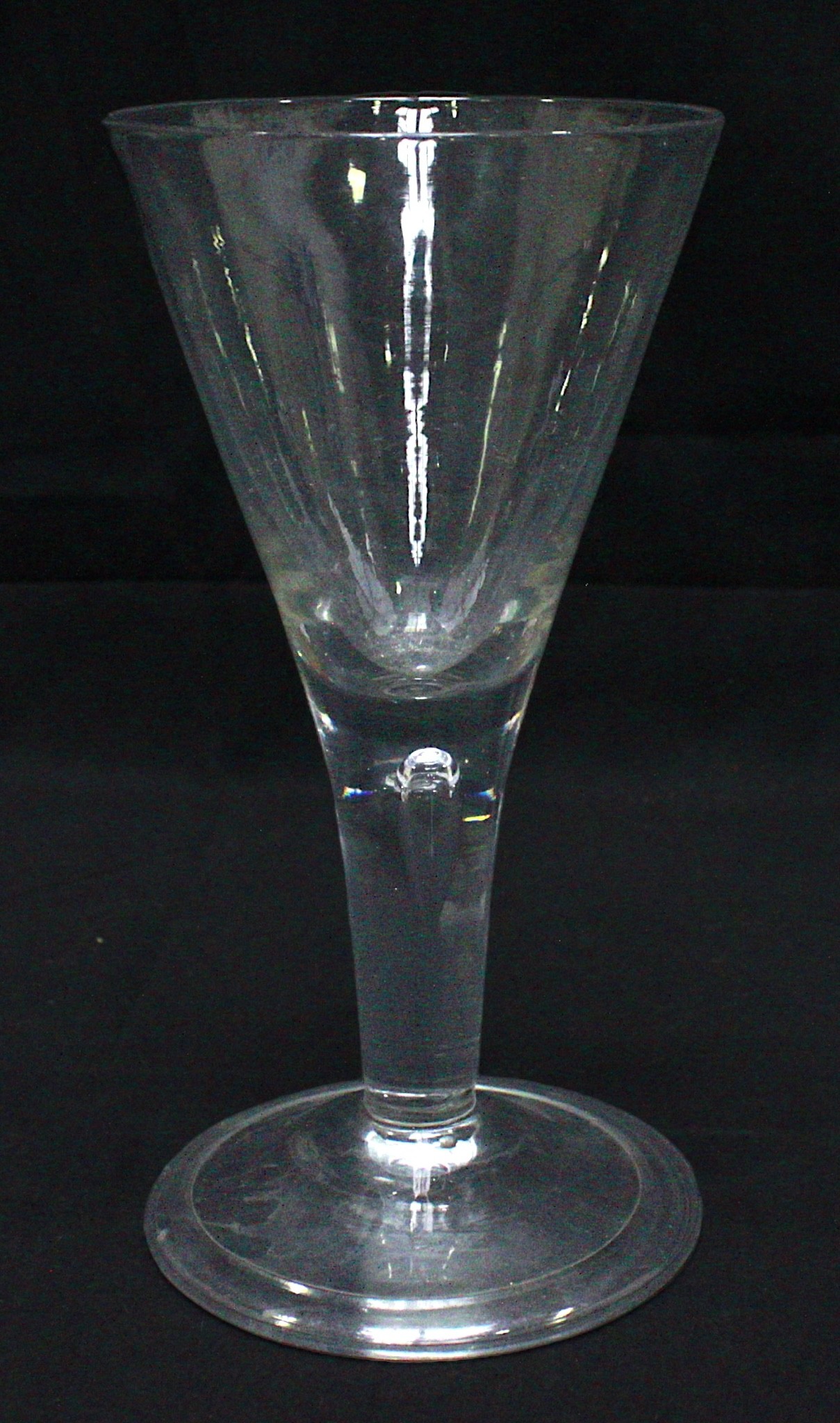 An 18th Century hand-Blown English Ale Glass, with one-piece trumper bowl and drawn teardrop stem,