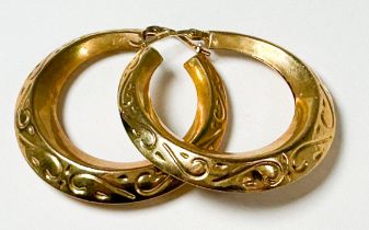 A pair of 9ct yellow gold large hoop earrings, with swirl and dash design, weight 6.4 grams.