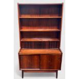 A 1960-70’s rosewood and teak bureau-bookcase with three shelves above a dual-tambor front enclosing