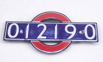 A London Underground enamel bullseye stocknumber identification plate, in the form of the iconic