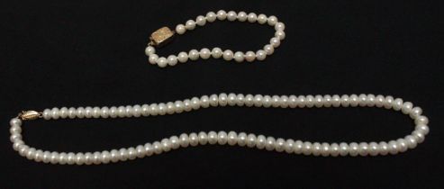 A cultured pearl necklace with 14k gold safety clasp, together with a cultured pearl bracelet with