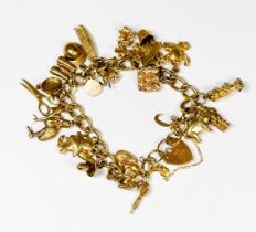 A 9ct yellow gold curb-link charm bracelet, with 24 x various gold charms including, a jockeys