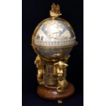 A Devon Clocks 'Greenwich Meridian' Clock, the ship finial above a gilt and plated terrestrial globe