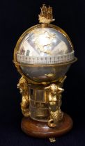 A Devon Clocks 'Greenwich Meridian' Clock, the ship finial above a gilt and plated terrestrial globe