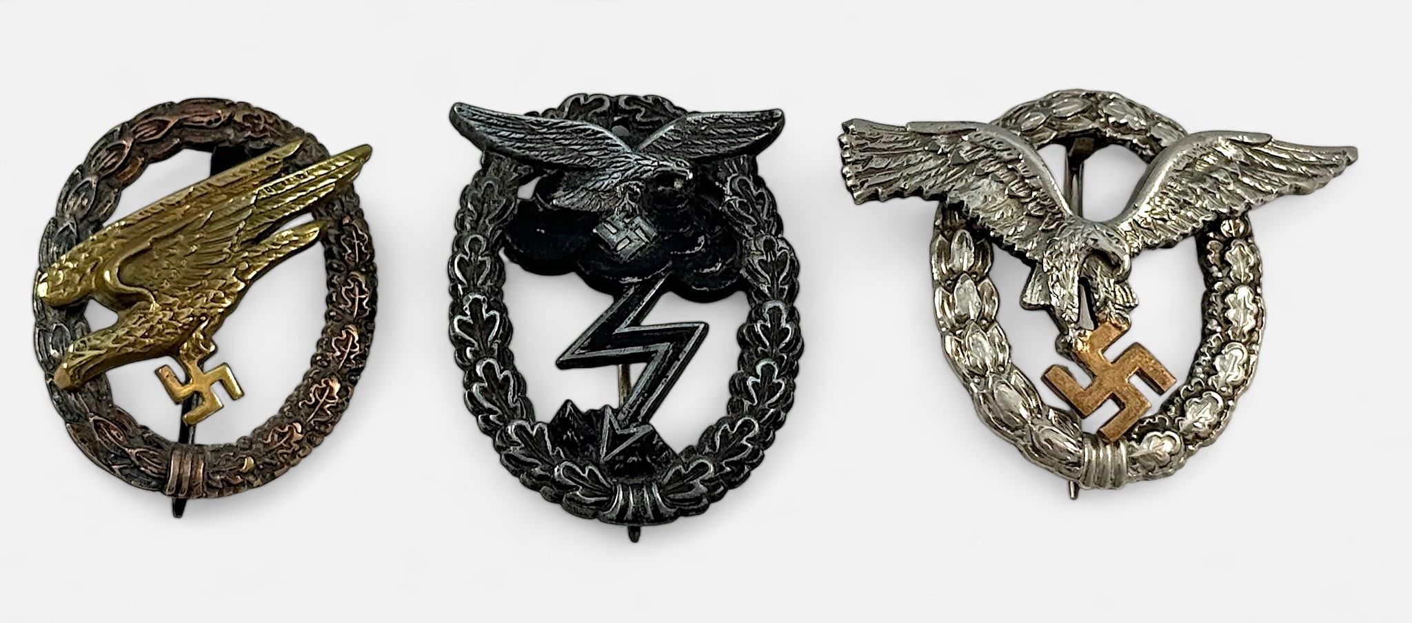 Three German Third Reich Luftwaffe badges including Pilots badge, Ground Assault badge,