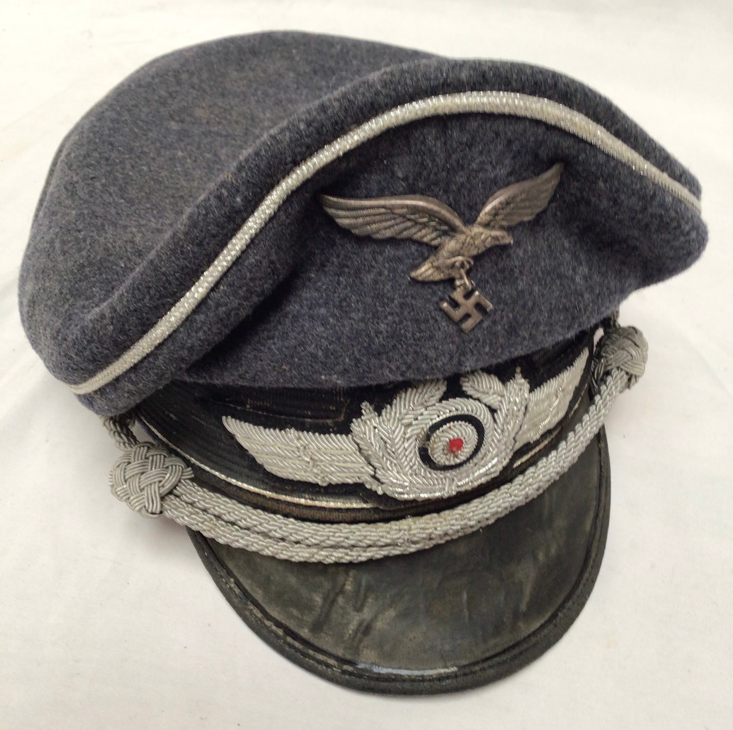 A German WWII Third Reich Luftwaffe side cap, together with a reproduction German WWII Third Reich