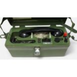 A cased GPO linesman’s portable field telephone, ‘PO 704B’, housed in green Bakelite case with