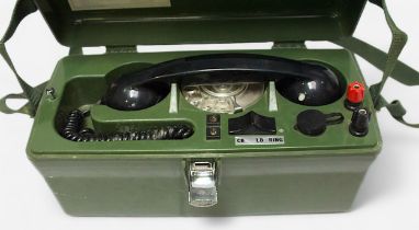 A cased GPO linesman’s portable field telephone, ‘PO 704B’, housed in green Bakelite case with