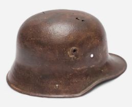 A WWI German M16 Stahlhelm steel combat helmet, lacking liner and chinstrap, splits and holes to