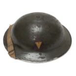 A British green painted steel Brodie helmet, with black leather lining and chin strap, stamped ‘T