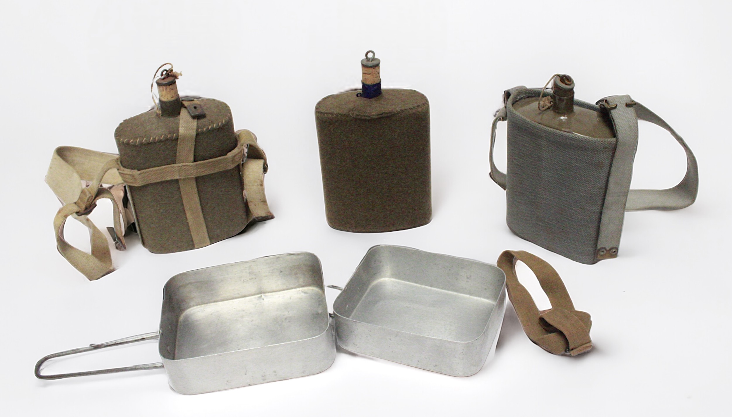 Three WWI enamelled metal water canteens with felt jackets, together with two aluminium mess tins.