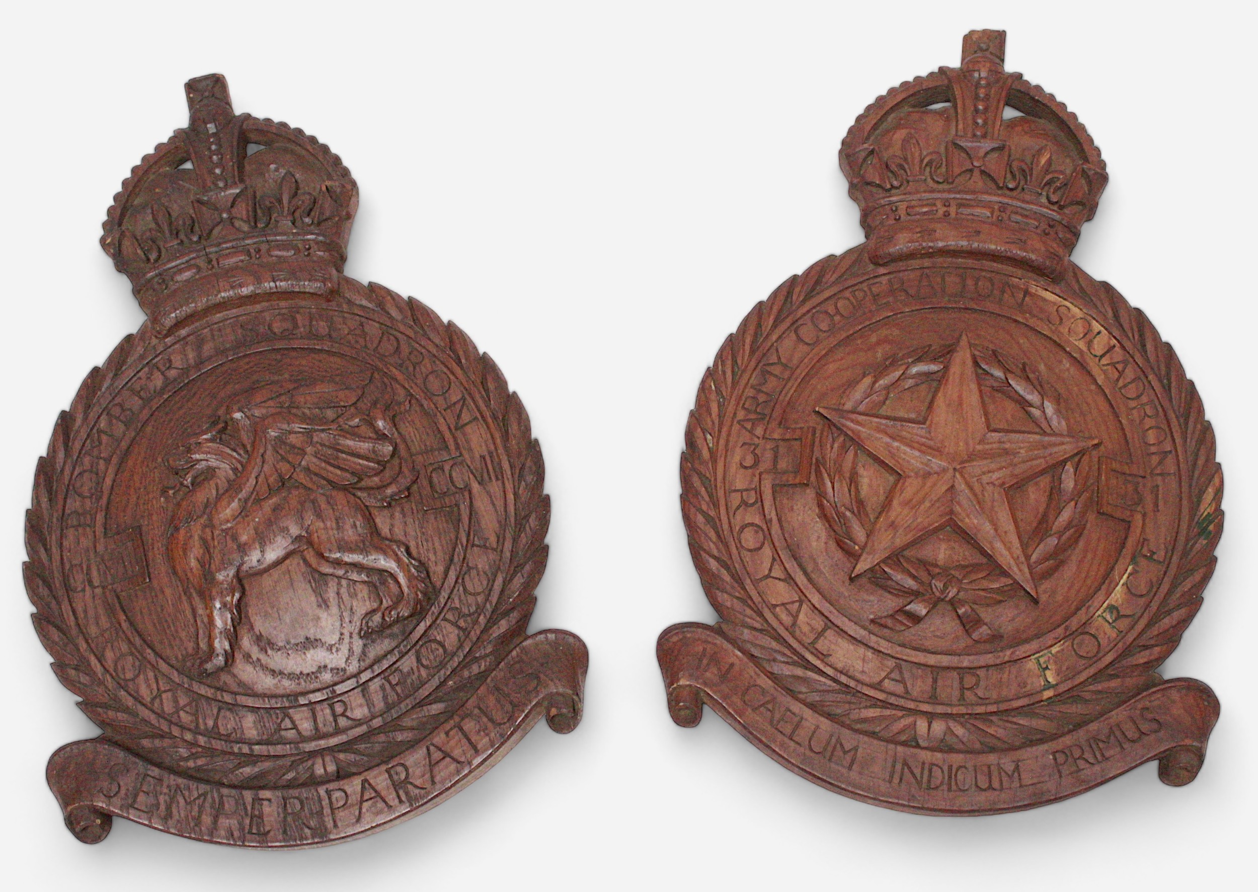 Two carved wooden wall hanging squadron badges, one for the Royal Air Force Army Co-operation