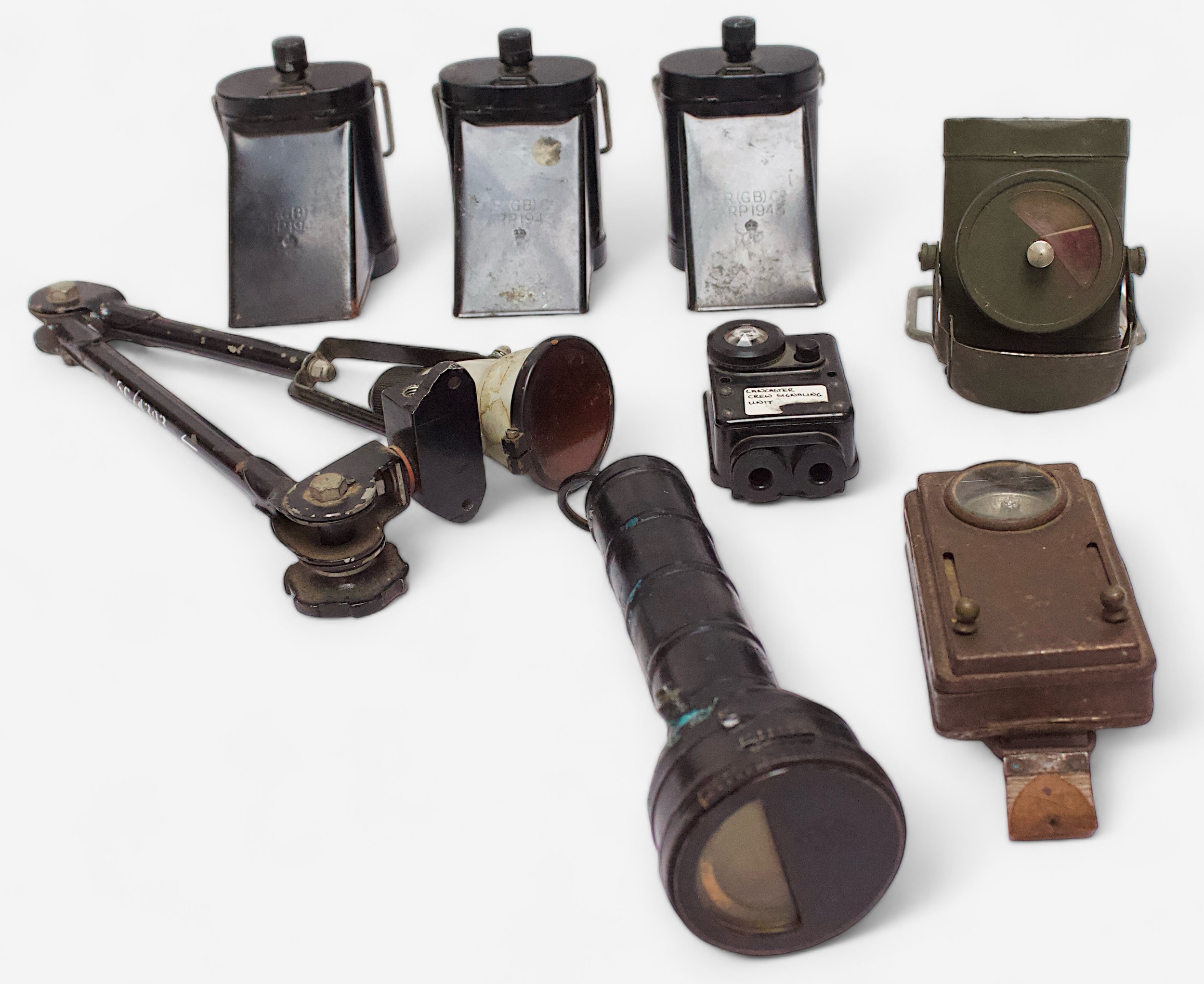 A collection of assorted WWII lamps, comprising three Air Raid Precautions (A.R.P.) lamps with