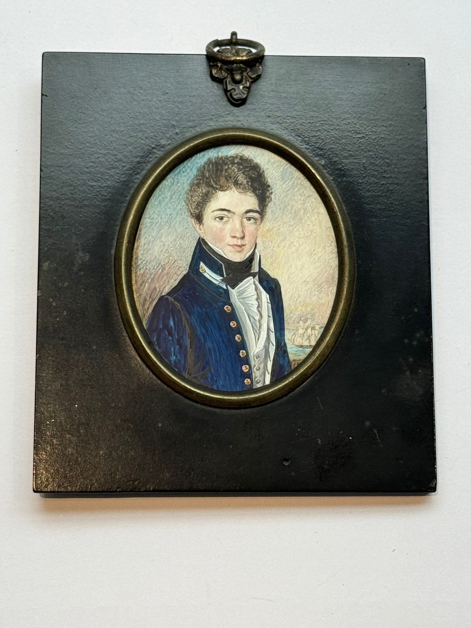 An early 19th century oval portrait miniature of a Junior naval officer, inscribed verso ‘c.1810,’