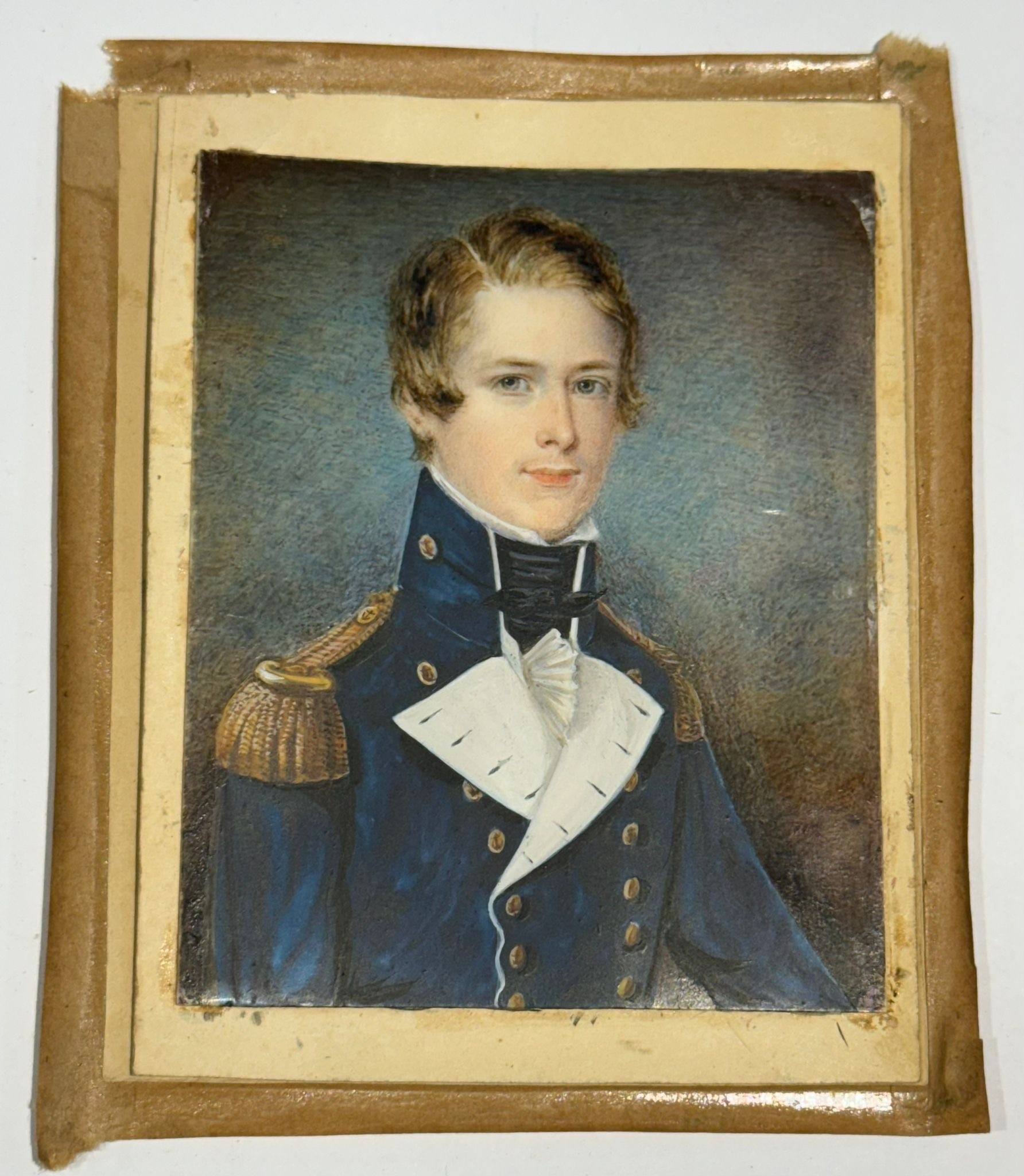 A Mid-19th century portrait miniature of a Naval Commodore, with brown hair with side parting,