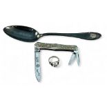 A silver plated tablespoon with applied 'SS' monogram, together with a sterling silver Skull ring,