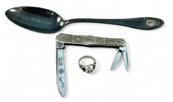 A silver plated tablespoon with applied 'SS' monogram, together with a sterling silver Skull ring,