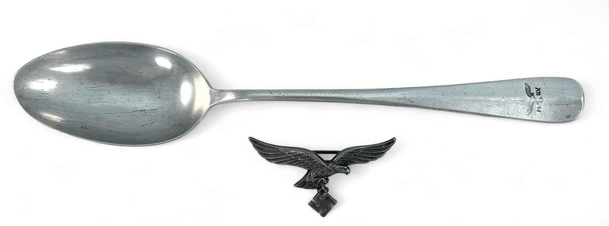 A German Third Reich Luftwaffe Officer's breast eagle, maker's mark 'A' D.R., together with a