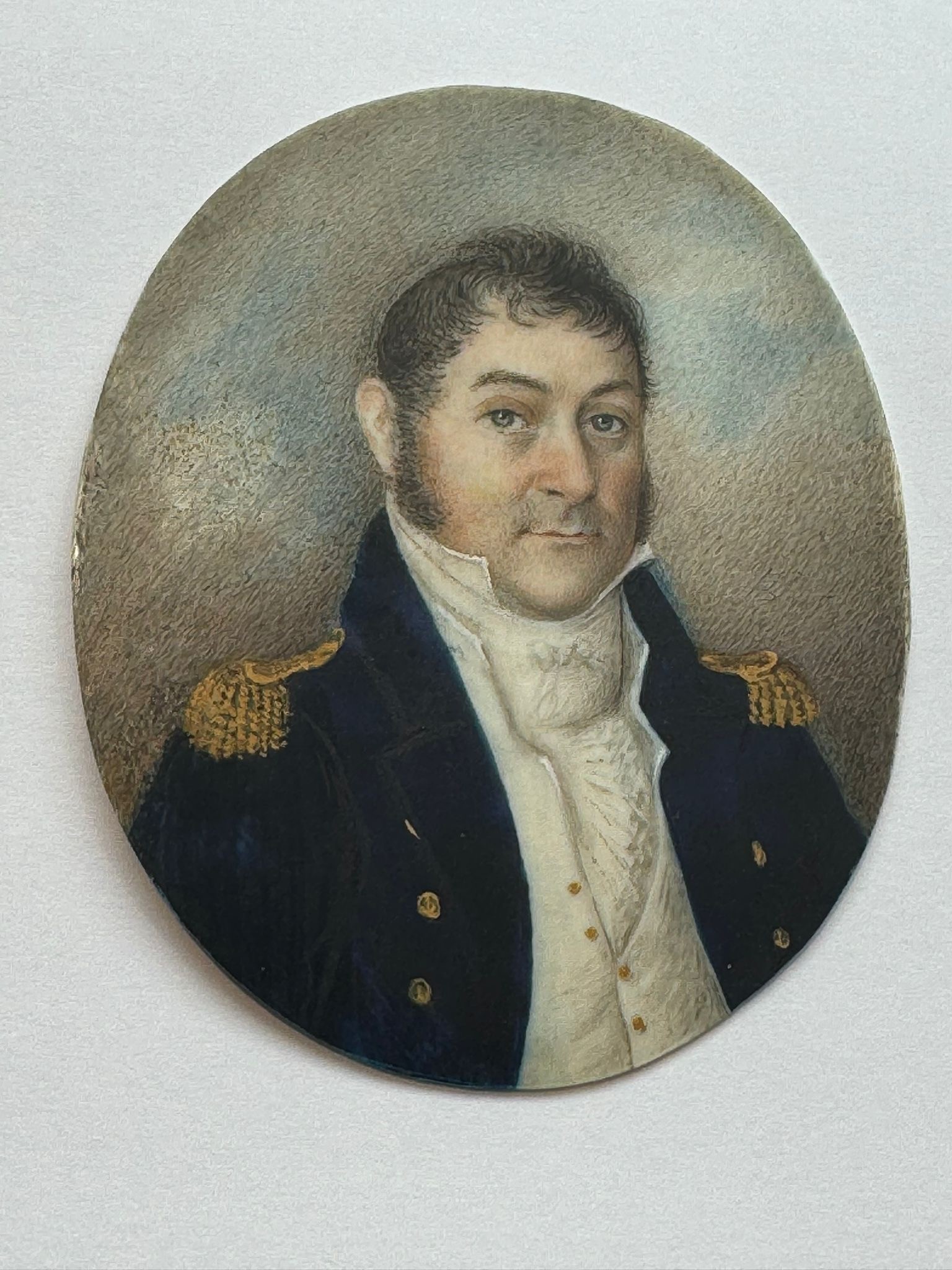 A 19th century oval portrait miniature of a middle-aged naval officer, with black hair and - Image 2 of 2