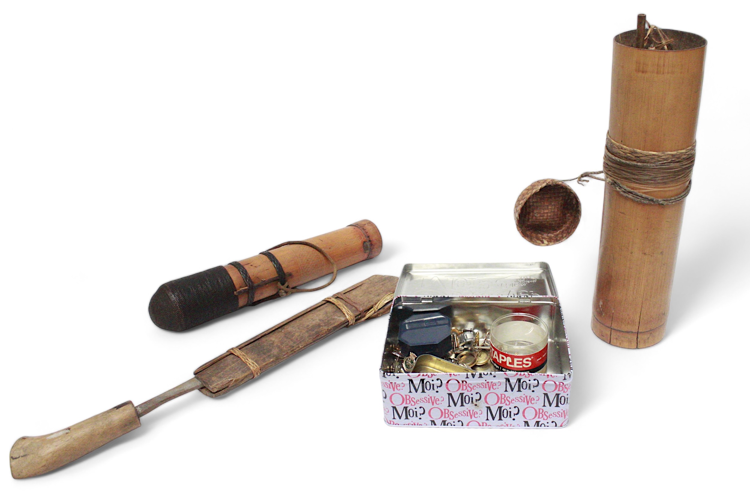 Two blow pipes with a collection of darts in bamboo containers and a curved dagger with sheath,