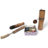 Two blow pipes with a collection of darts in bamboo containers and a curved dagger with sheath,