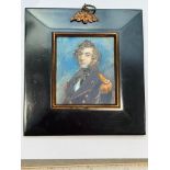 A Mid-19th century portrait miniature of a Naval Commander or Captain, with long curly brown hair