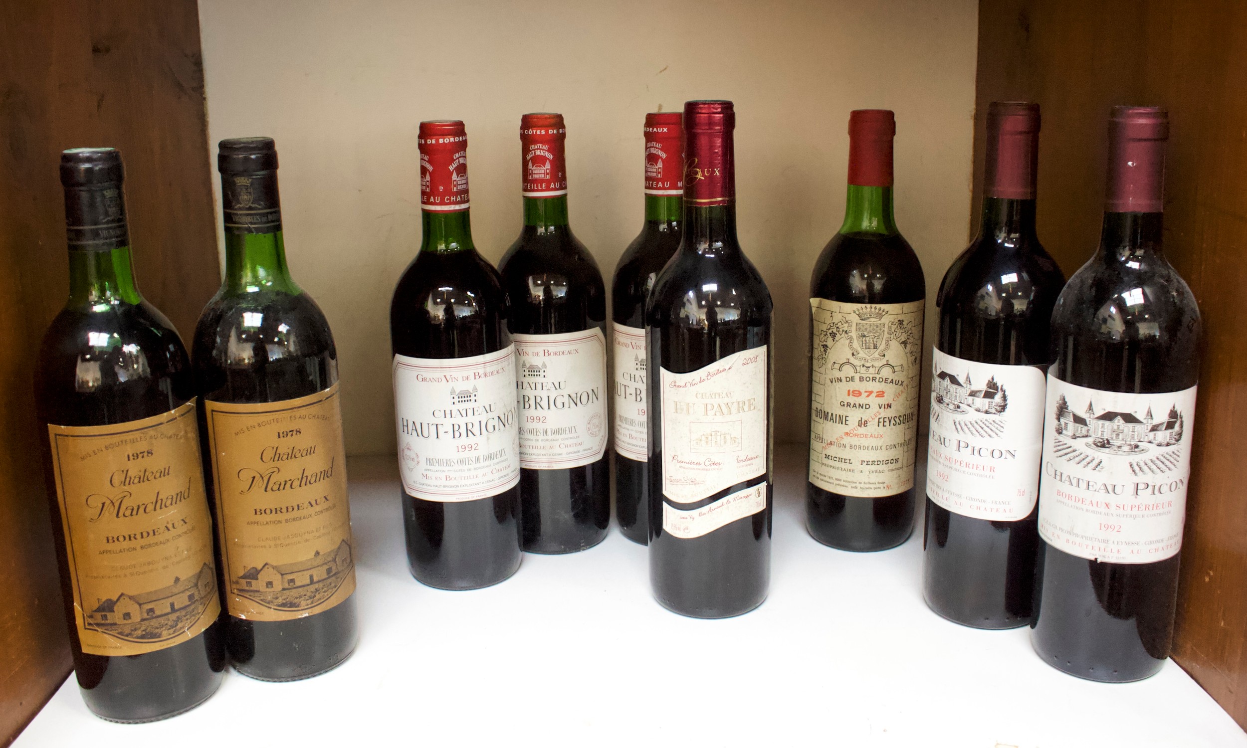 A collection of nine bottles of assorted vintage red wine, comprising two bottles of Chateau Picon