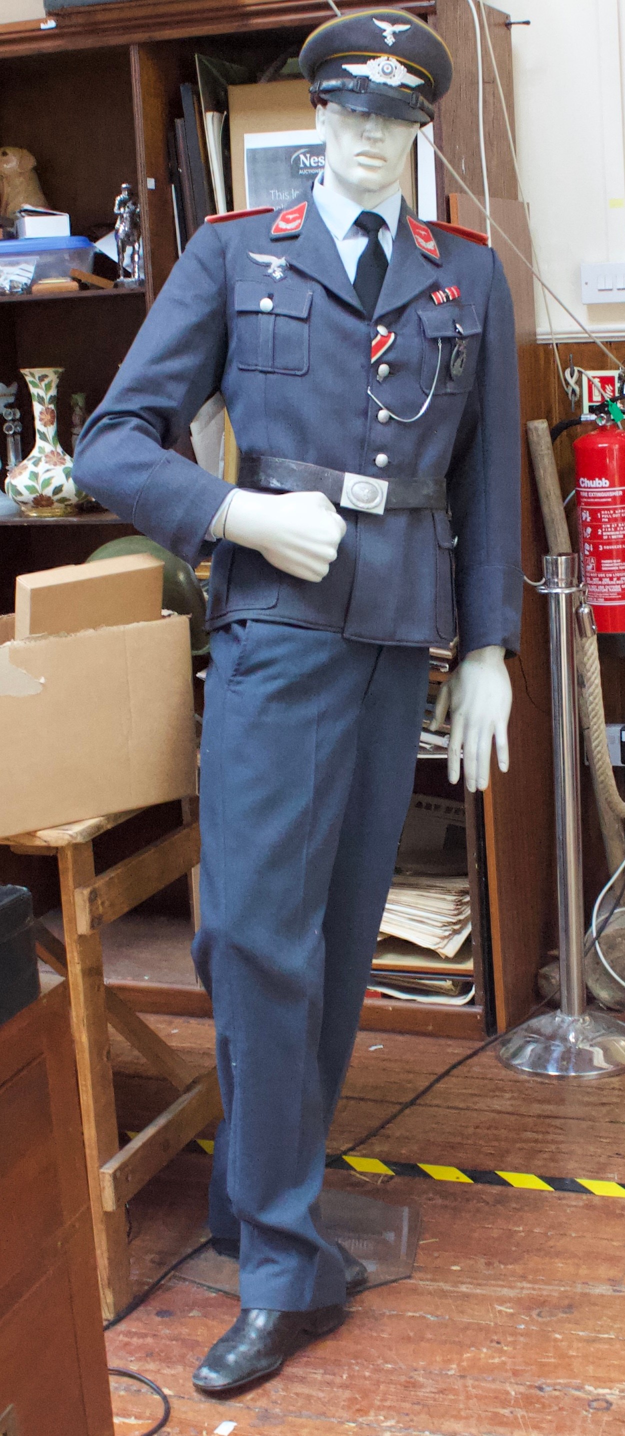 A WWII German Third Reich Luftwaffe uniform on mannequin dummy, comprising peaked cap, jacket with