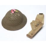 A British WWII Home Guard Brodie helmet with net cover, dated 1941, stamped ‘BMB’, together with a