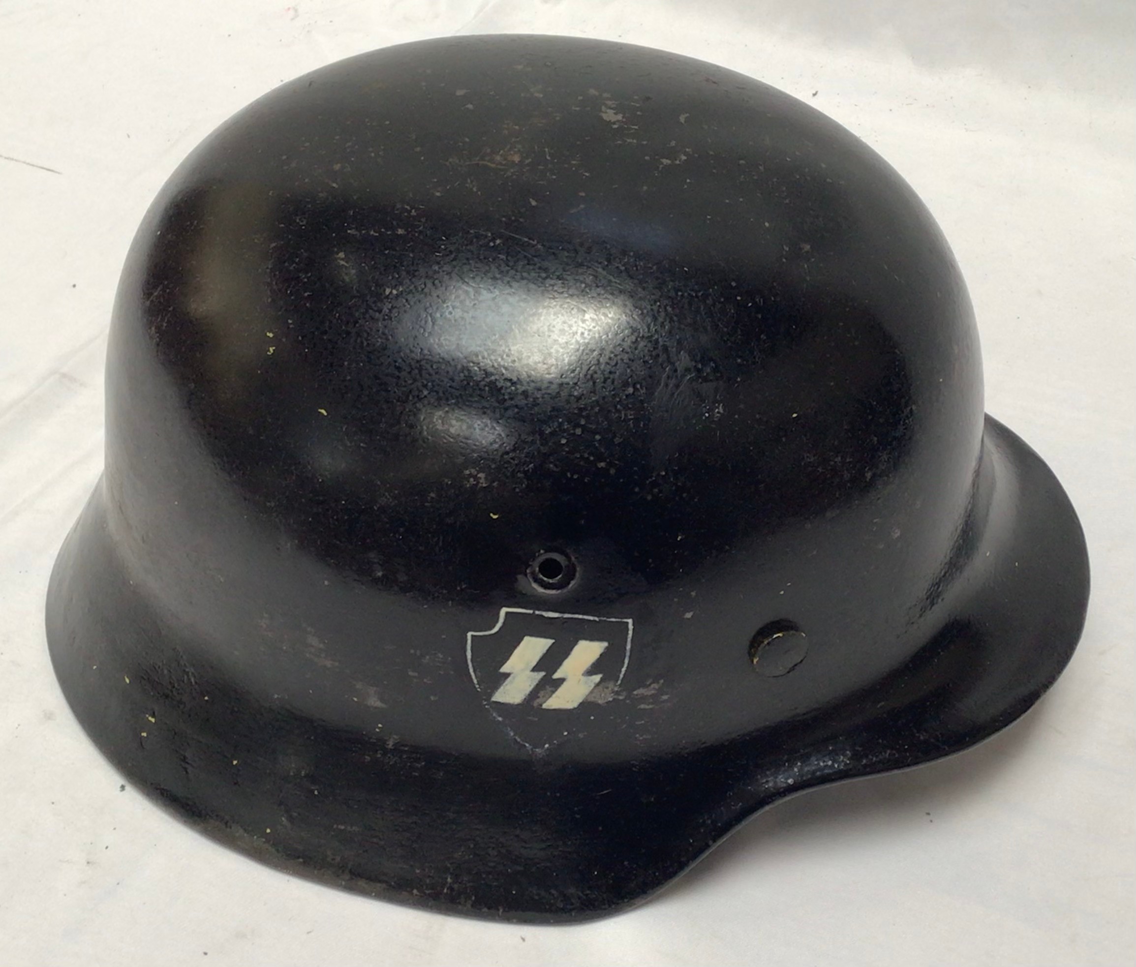 A WWII German Third Reich M40 helmet, numbered ET66 5070, with eight-tongue leather liner, black