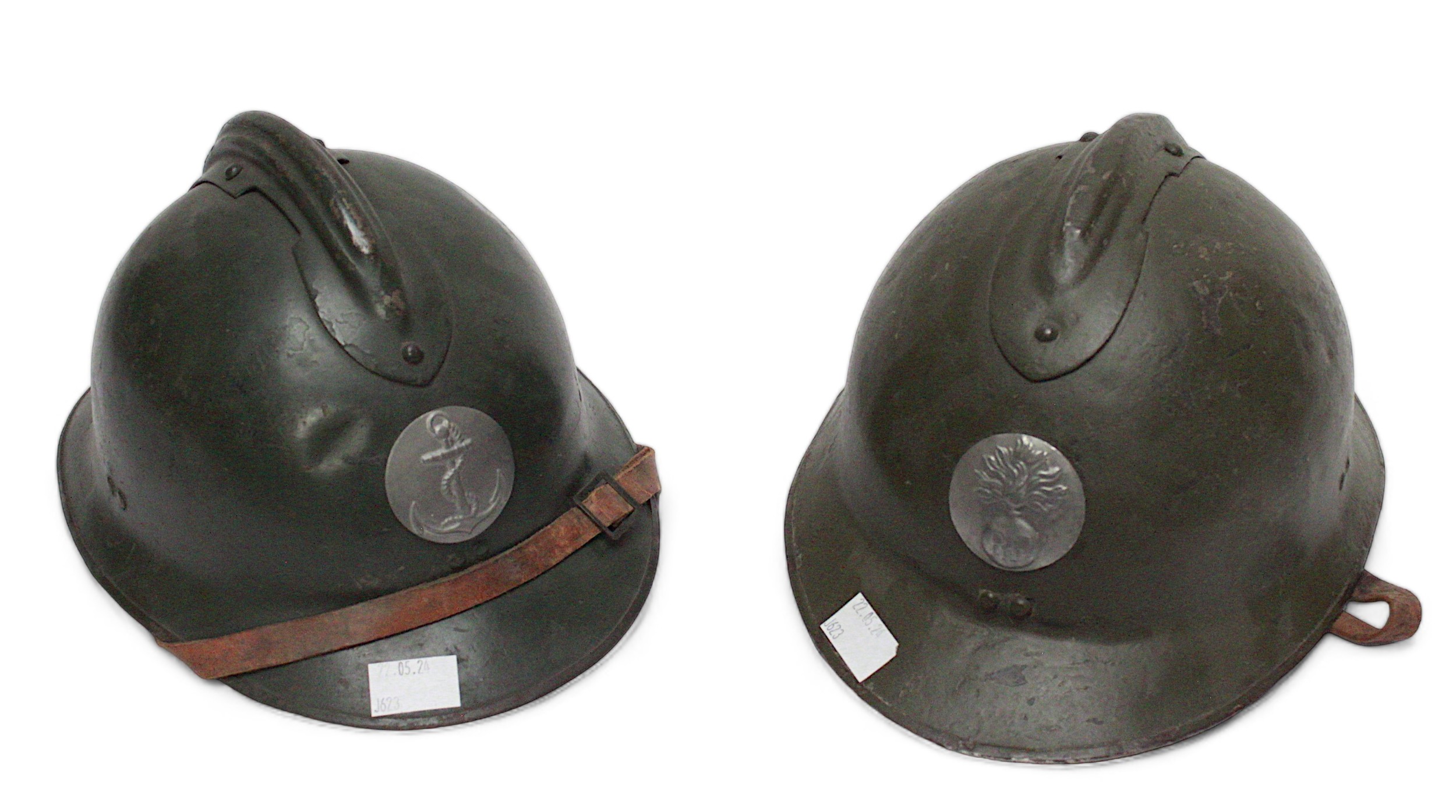 Two French WWI era steel Adrian type helmets, both with leather linings and chin straps, one with