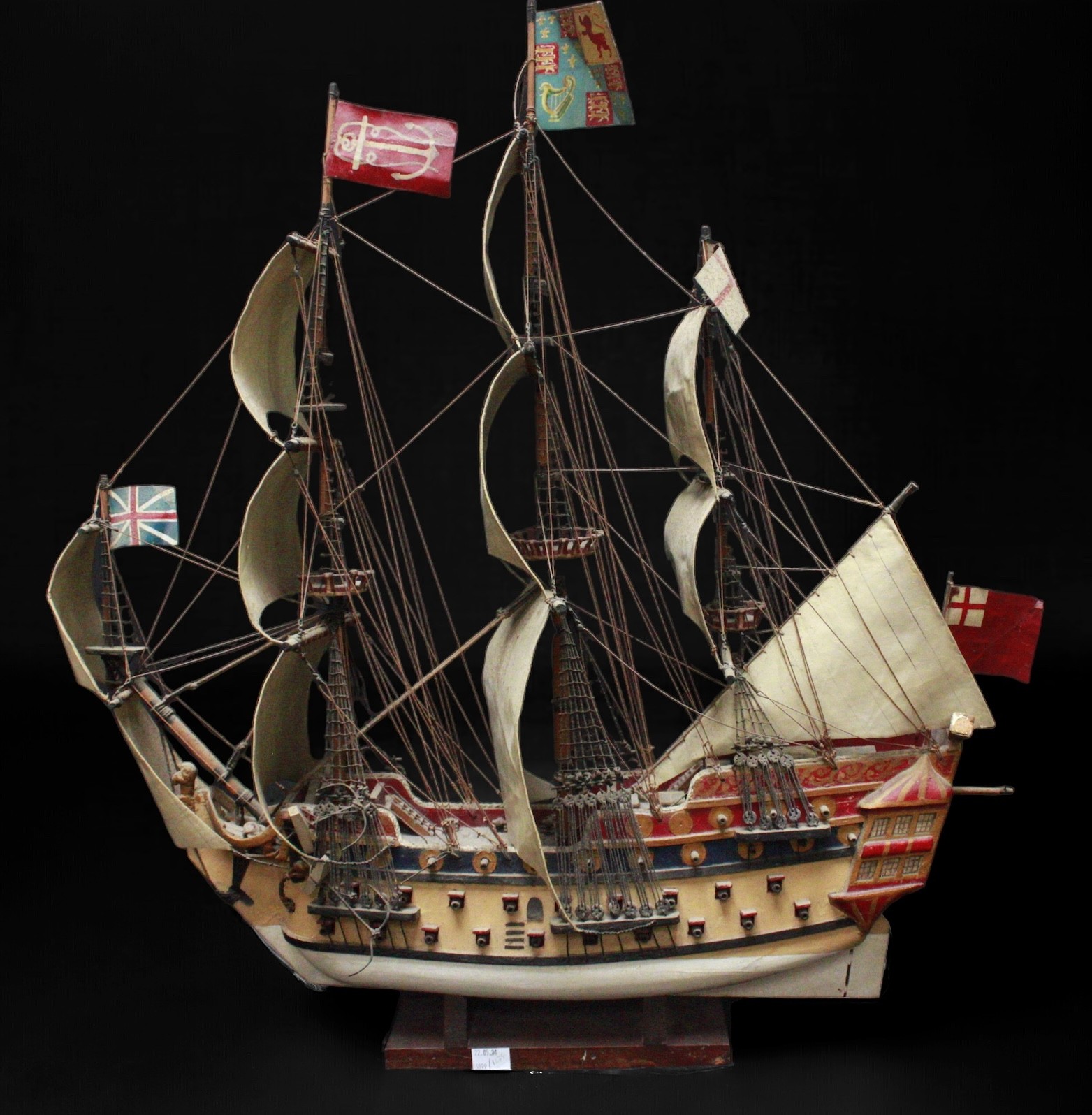 A scratch built wooden three masted model ship in full sail, with two gun decks and rigging, with