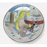 A glazed terracotta charger depicting a fisherman smoking a pipe, with the sea and a lighthouse