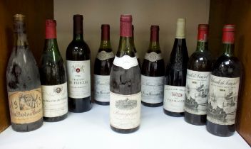 A collection of ten assorted bottles of vintage red wine including a 1973 vintage Saint Nicolas