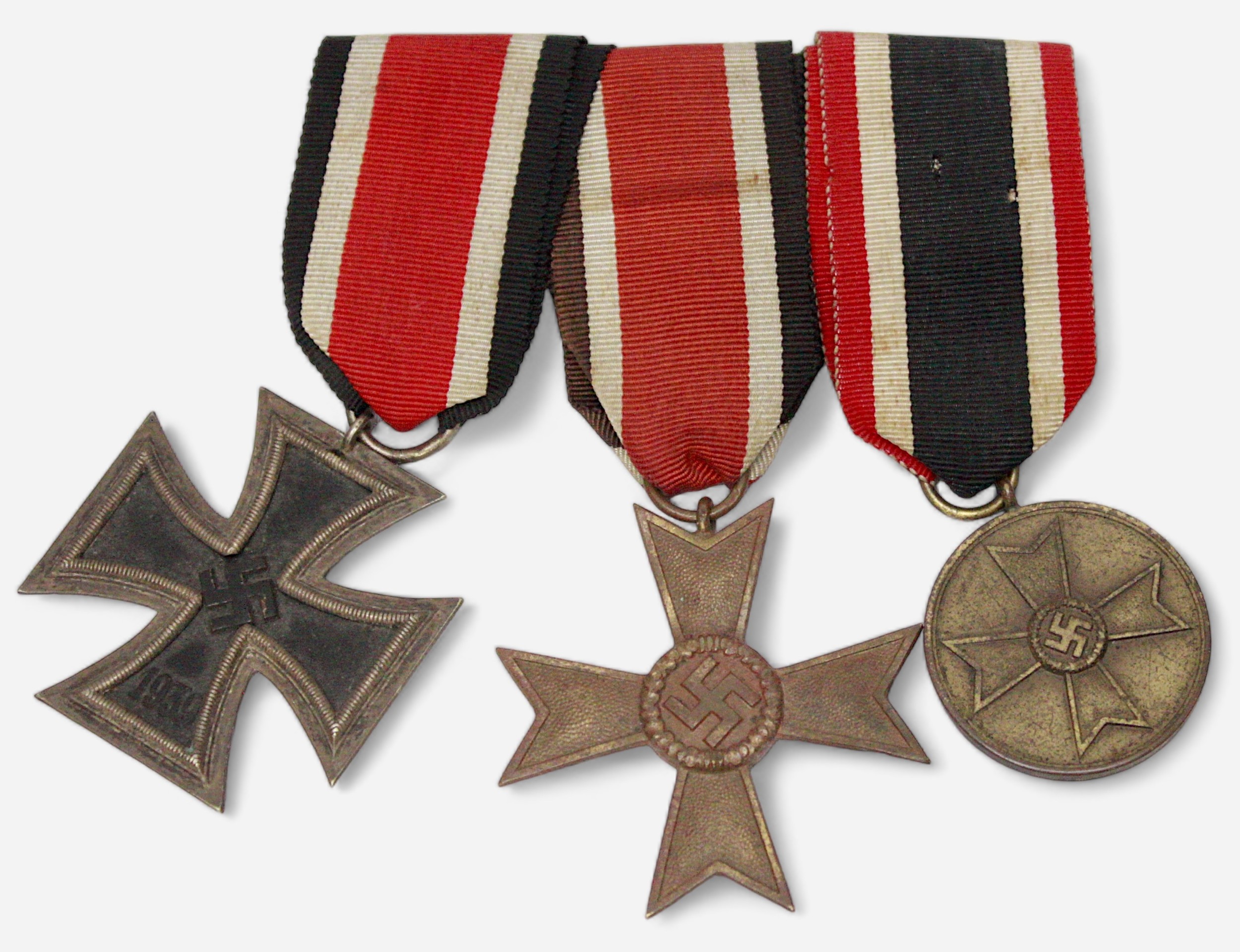 A German WWII three medal group, comprising Iron Cross, 2nd Class, War Merit Medal and War Merit