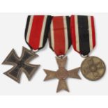 A German WWII three medal group, comprising Iron Cross, 2nd Class, War Merit Medal and War Merit