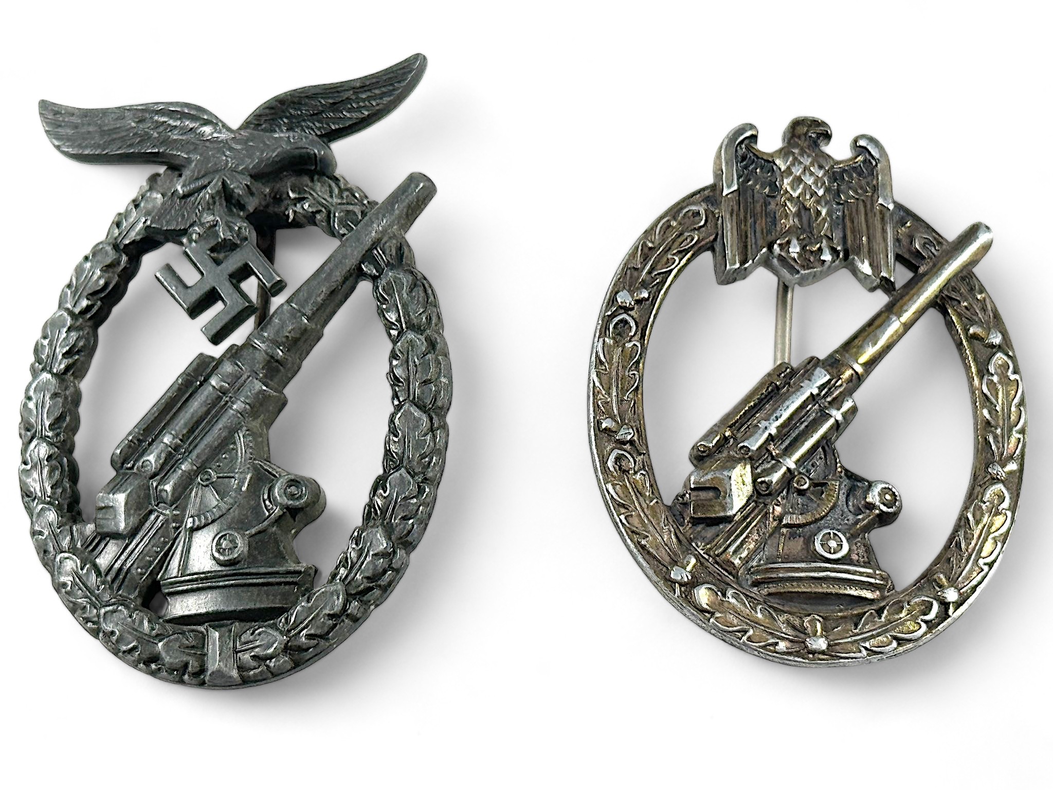 A German WWII Luftwaffe Flak badge, the reverse with raised mark 'WH,' together with a Heer Flak
