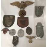 WWII German Third Reich: Four campaign shields, and seven various badges. (11)
