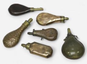 Six various powder flaks, including three pressed sheet brass, one leather and one horn example. (