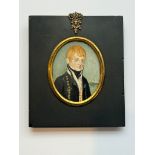 A 19th century oval portrait miniature of a young Naval Midshipman, with red hair, body turned