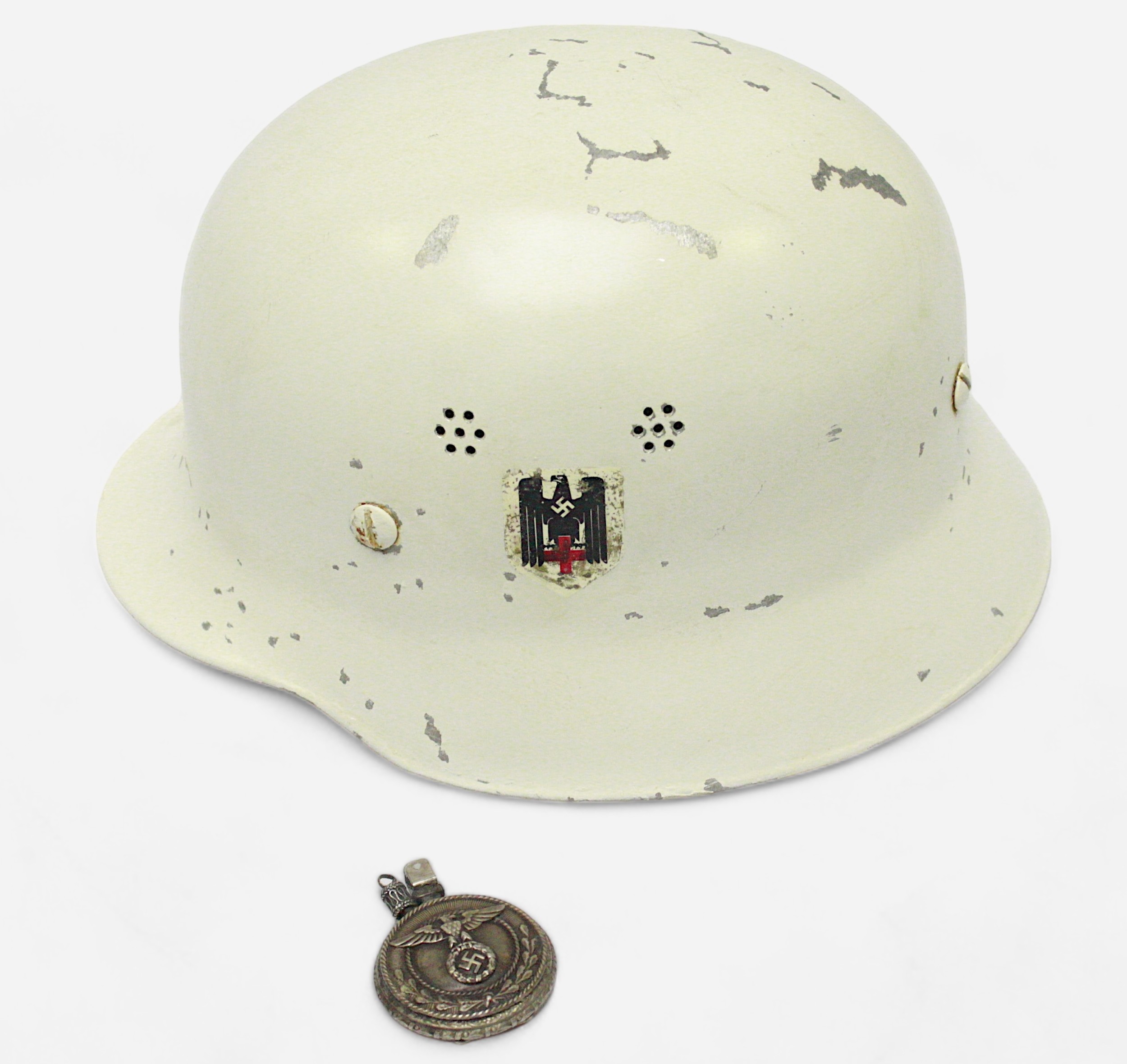 A German M40 helmet, probably for Police or Fire service, finished in white and stamped ‘Din 14940’,
