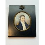 A 19th century oval portrait miniature of a middle-aged naval officer, with black hair and